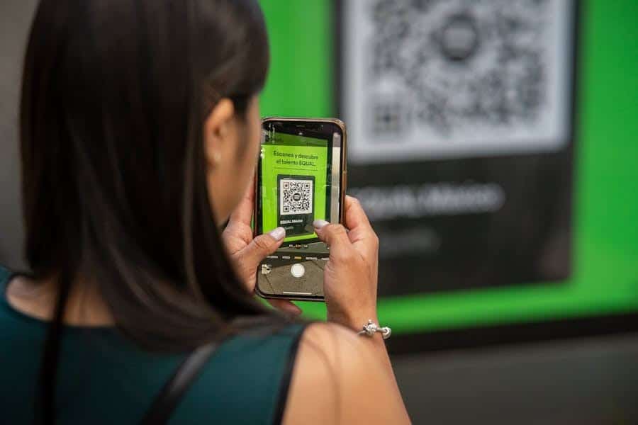 Woman holding up her phone to capture QR code
